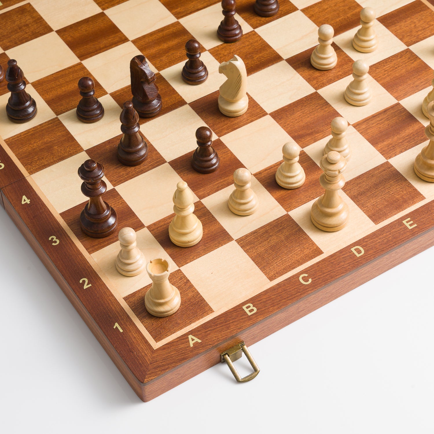 Wooden chessboard with pieces on a light gray background