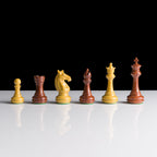 Set of chess pieces on a reflective surface with a black background